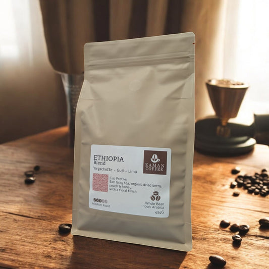 ZAMAN COFFEE Ethiopia blend medium roast whole bean coffee bag on a wooden table with scattered coffee beans